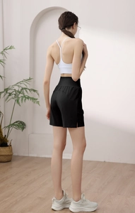 Detail of high waisted nylon athletic shorts with a stylish side slit design for women