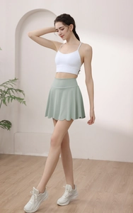 Detail of high-waisted petal hem yoga skirt in light green with moisture-wicking fabric
