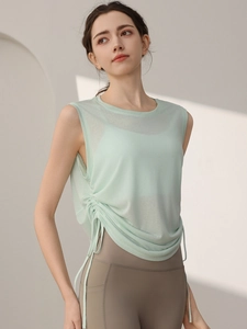 Light green sleeveless yoga vest with drawstring side detail and relaxed fit