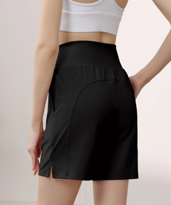 Rear view of black high-waisted nylon sports shorts with curved stitching and side slit detail