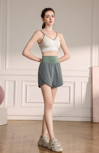 Detail of high-waisted grey sports shorts with a green waistband for yoga and fitness