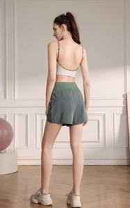 Rear view of high-waisted loose sports shorts with quick-dry fabric in a gym setting