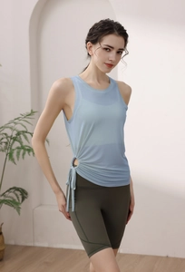 Detail of light blue yoga tank top with side drawstring and olive green cycling shorts