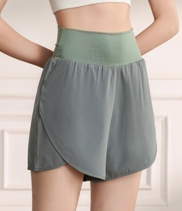 Close-up of double-layer high waist sports shorts showing the curved hem and breathable fabric