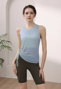 Detail of light blue yoga tank top featuring adjustable side drawstring and mesh fabric