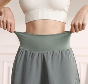 Close-up of high-elastic wide waistband on sage green quick-dry sports shorts for yoga
