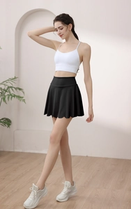Detail of high-waisted black tennis skirt with petal scalloped edge and athletic fit