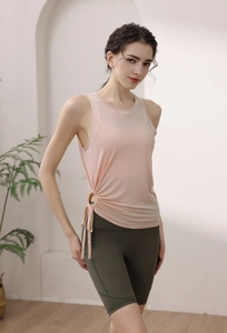 Detail of light pink drawstring yoga tank top with side ruching and mesh fabric textures