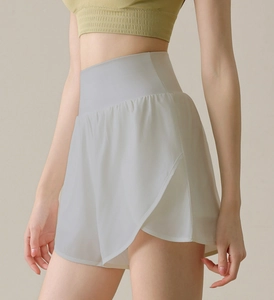 Detail view of double-layer white high-waisted sports shorts with breathable fabric