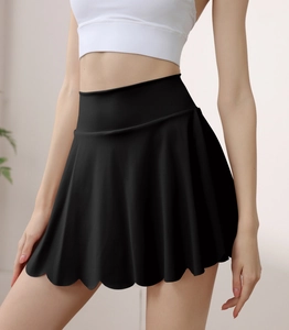 Detail of high waisted black tennis skirt with scalloped edge and athletic fabric