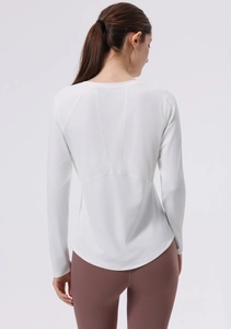 Close-up back view of white long-sleeve yoga top featuring professional flatlock stitching