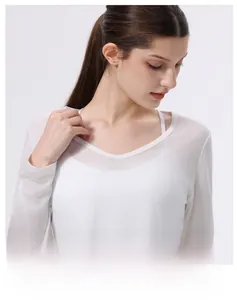 Dettaglio del top bianco in Lyocell con scollo a V, vestibilità slim e tessuto trasparente