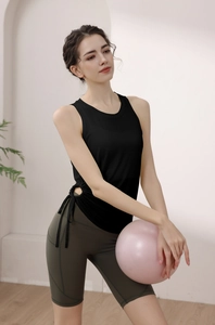 Detailed side view of black yoga tank top with unique waist drawstring and hollow design