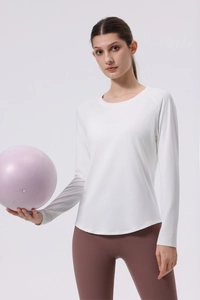 Detailed back view of white long sleeve yoga top with ergonomic curved hem and smooth seams