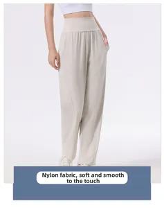 Close-up of beige high-waisted yoga pants made from smooth, soft nylon fabric with pockets