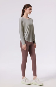 Detail view of seamless four-needle six-thread stitching on grey-green yoga long sleeve shirt
