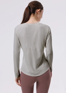 Detail of light grey yoga top with flatlock stitching and curved hem on the back