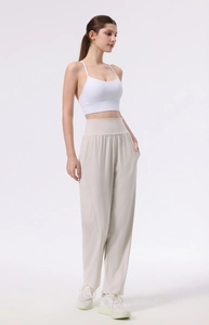 Full view of high waist wide leg yoga pants and white sports bra on model