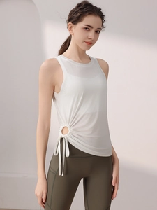 Women's white yoga tank top with side drawstring detail and olive green leggings
