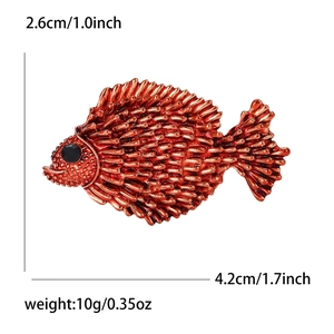 Detail view of fish brooch showing 4.2x2.6cm size and red bronze scale texture