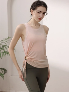 Women's light pink yoga tank top with stylish side drawstrings for fitness and running