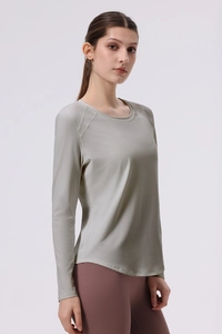 Detail view of light green raglan sleeve yoga top with breathable quick-dry fabric