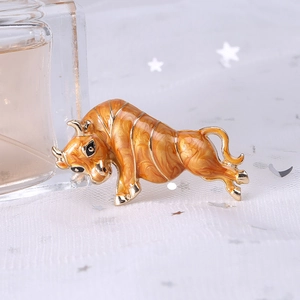 Detail of enameled bull brooch with orange marble texture on vintage gold plating