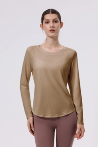 Detail of khahi long sleeve yoga top with thumbholes and curved hemline design