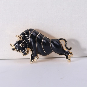 Detail of bull brooch showing black enamel finish and gold metallic outline on suit accessory