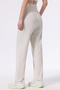 Macro shot of high waist band showing peach-hip seam on beige sports trousers