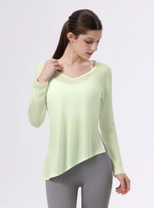 Dettaglio del top yoga verde chiaro con scollo a V, orlo asimmetrico e tessuto mesh