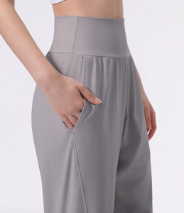 Detail of high waisted yoga pants with side pocket and smooth moisture-wicking fabric