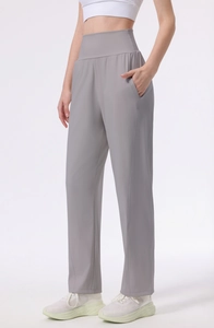 Detail view of high-waisted wide-leg gray yoga pants with side pockets and slim stitching