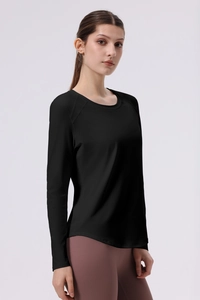 Close-up of black long sleeve yoga top featuring four-needle six-thread seams and curved hem