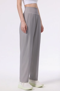 Detailed side view of high-waisted grey wide-leg yoga pants with premium draped fabric