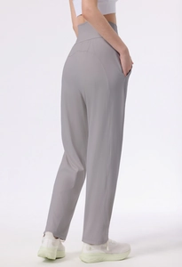 Detail view of high-waisted grey yoga pants with wide waistband and side pockets