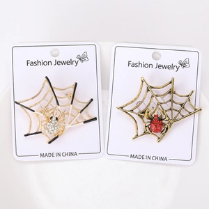 Detailed view of fashion spider web brooches with sparkling rhinestones on display cards
