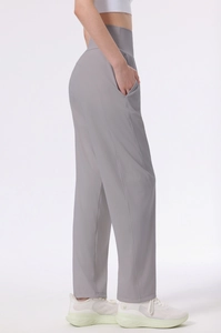 Detail view of light grey high-waisted yoga pants with invisible side pockets and straight leg