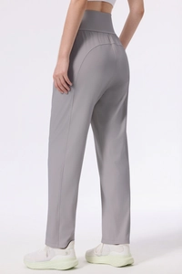 Detail showing the curved back seam and lifting effect of gray yoga pants