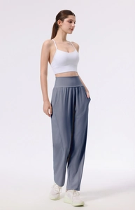 Full body view of high waist wide leg yoga pants and white sports bra with side pockets