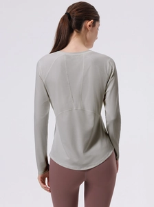 Women's sage green seamless long sleeve yoga top with ergonomic stitching and slim fit design