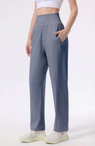 Detail view of high waisted grey blue yoga pants with functional side pockets