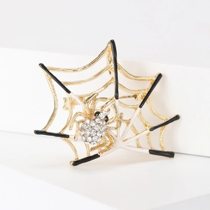 Detailed macro view of a gold spider web brooch with sparkling inlaid rhinestones