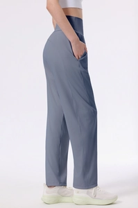 Detail view of high-waisted blue-grey athletic wide-leg pants with hidden side pockets