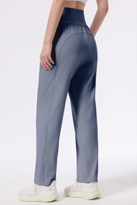 Detail view of high-waisted gray-blue yoga pants with flattering curved back seams
