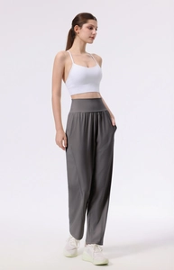 Detail of high-waist grey wide-leg sports trousers with functional side pockets
