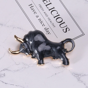 Macro shot of a bull brooch in gold-plated alloy with grey marble enamel finish