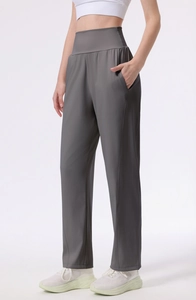 Detail of high waisted dark gray yoga pants showing wide waistband and side pocket detail