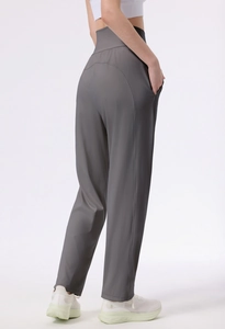 Detail view of high waist dark gray yoga pants with side pockets and slimming fit