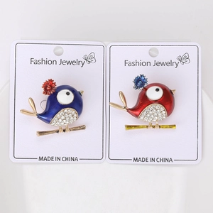 Detail of bird brooches with colorful enamel finish and sparkling crystal rhinestones